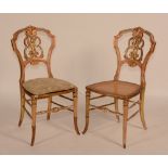 A set of four Victorian giltwood parlour chairs, circa 1860, with caned seats and monogrammed backs,