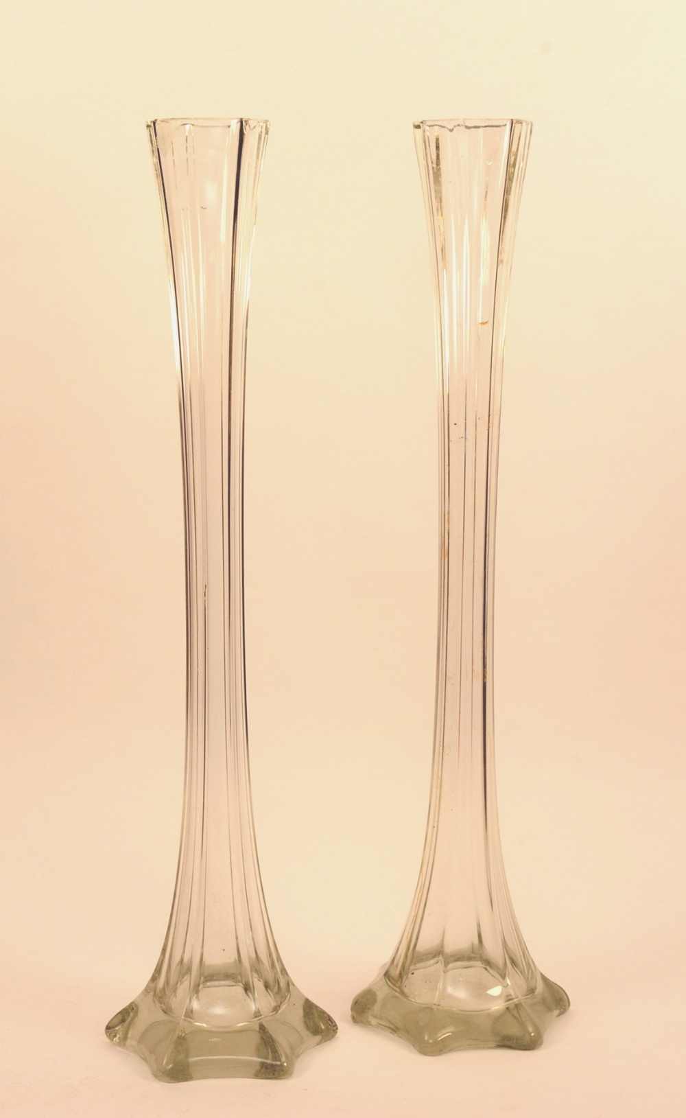 A pair of tall glass vases, circa 1910, of narrow flared form,