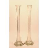 A pair of tall glass vases, circa 1910, of narrow flared form,