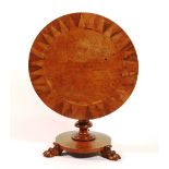 A William IV pollard oak and rosewood centre table, with circular top and column stem,