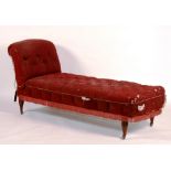 A Victorian chaise longue, upholstered in buttoned red fabric (a/f),