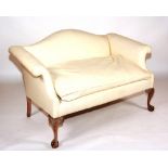 An upholstered settee, raised on cabriole legs with ball and claw supports,