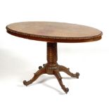 A 19th century Anglo-Indian mahogany table, circa 1825, the oval top above shallow drawer to frieze,