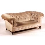 A Victorian Chesterfield sofa, circa 1890, with upholstered frame and turned feet,