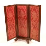 A William IV mahogany dressing screen, with three sections upholstered in floral fabric,