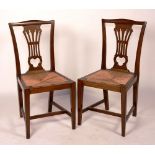A pair of Edwardian mahogany dining chairs, circa 1910, with rushwork seats,