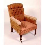 A Victorian upholstered armchair, with button back, raised on turned mahogany supports,