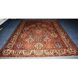 A Bachtiar carpet, decorated with blue and cream geometric motifs on red ground,
