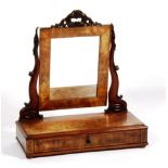 An early Victorian mahogany dressing glass, circa 1840, with scroll supports and drawer to base,