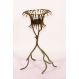 An iron jardiniere, with basket top raised on stylized supports,