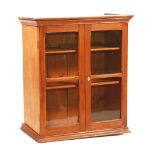 An oak wall cabinet, circa 1880, glazed with two shelves,