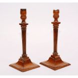 A pair of George III mahogany candlesticks, circa late 18th/early 19th century,