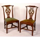 A pair of George II mahogany dining chairs, circa 1755, with interlaced splats and drop in seat,