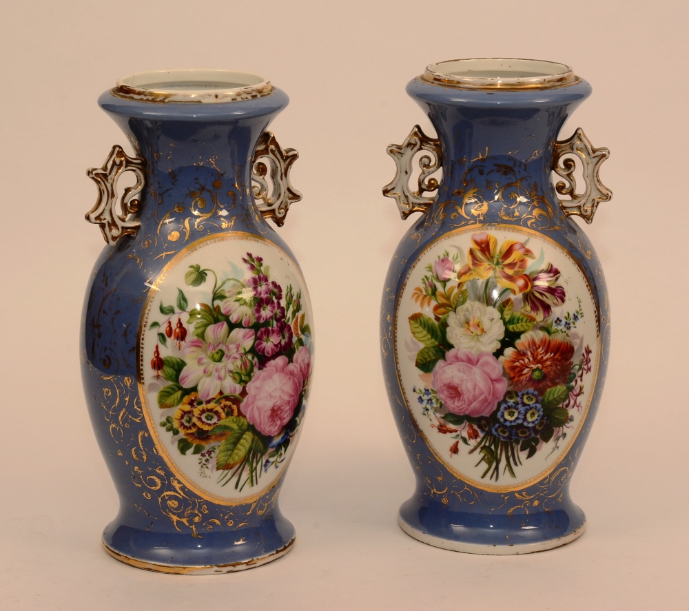 A pair of French porcelain vases with floral panels on an Hyacinth blue ground,