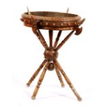 A French walnut 'Crusader' jardiniere, circa 1870, with axe head supports,
