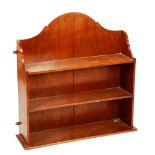 A set of mahogany hanging wall shelves, circa 1890, with curved cresting,