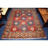 A Persian pinwheel design rug, decorated with geometric motifs, in blue, green and cream,