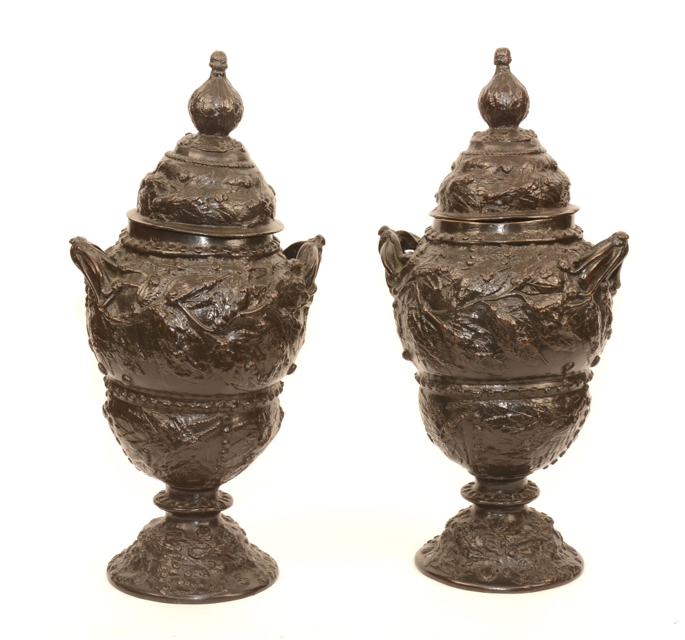 A pair of large bronze vases with covers, circa 19th century, with leaf decoration,