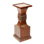 A mahogany plant pedestal, raised on square column,