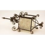 A wrought iron ceiling frame, circa late 19th century, with scroll decoration and glass panels,