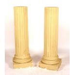 A pair of painted plaster pedestal columns,