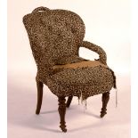 A Victorian library armchair, raised on mahogany supports,