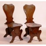 A pair of George III mahogany hall chairs,