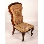 An early Victorian rosewood and needlepoint armchair, circa 1840, raised on cabriole supports,