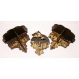 A set of three Japanned wall brackets circa 1910, graduated sizes,