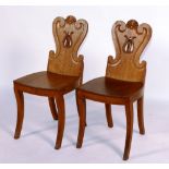 A pair of George IV oak hall chairs, circa 1820,