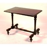 A Victorian ebonised centre table, the rectangular top raised on turned columns and supports,
