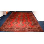 An Ushak carpet, decorated with large geometric motifs and floral border on red ground,