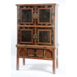 A Chinese lacquered cabinet on stand, circa late 19th century, with carved stiles and panels,