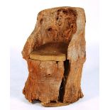 An unusual tree-trunk chair, carved from one piece of trunk,