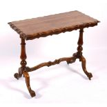 A Victorian rosewood side table, the shaped top raised on turned columns and scroll supports,