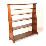 A mahogany waterfall bookcase, circa 19th century, of tapering form with five open shelves,