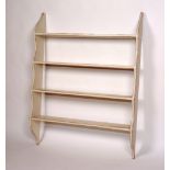 A painted wall hanging open bookcase, with four tiers,