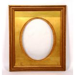 A gilt picture frame, with glass front, oval insert,