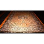An Indian Ushak style carpet, decorated with central blue motif on beige ground,