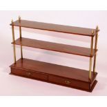 A set of mahogany hanging shelves, circa 1910, with base drawer and gilt-metal supports,