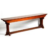 A long refectory style mahogany table, in the form of a bench,