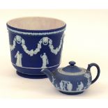 A Wedgwood Jasperware blue and white planter, decorated with classical figures, fruit and vines,
