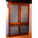 An early Victorian mahogany bookcase circa 1841, the two sections with grill-fronted doors,