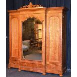 A Victorian breakfront maplewood wardrobe, circa mid 19th century, with central mirrored door,