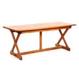 An Arts & Crafts oak refectory table, the rectangular top raised on X-form supports,