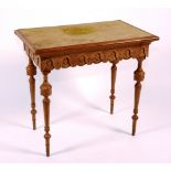A French walnut writing table, circa 1860, with carved frieze,