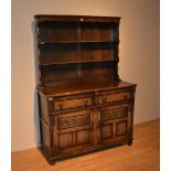 An oak kitchen dresser, with two tier Delft rack above two drawers and two panelled doors,