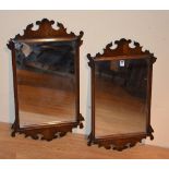 A pair of mahogany framed fret work wall mirrors in the George II style, 69.