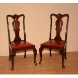 A set of four Queen Anne style mahogany dining chairs, raised on cabriole supports,