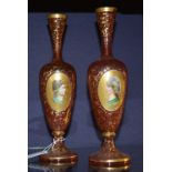 A pair of Victorian cranberry glass and enamel vases, the enamel plaques depicting soldiers,